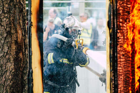 Reims France May 18, 2019 View of firefighters extinguishing a construction hut burned by rioters during protests of the Yellow Jackets in the streets of Reims on saturday afternoonのeditorial素材