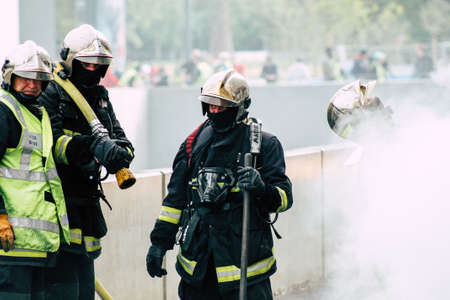 Reims France May 18, 2019 View of firefighters extinguishing a construction hut burned by rioters during protests of the Yellow Jackets in the streets of Reims on saturday afternoonのeditorial素材