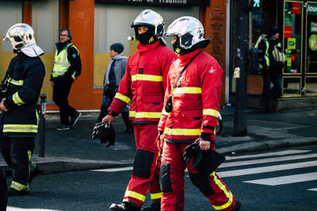 Paris France May 04, 2019 View of a French firefighters walking in the street during protests of the Yellow jackets against the policy of President Macron in Paris on saturday afternoonのeditorial素材