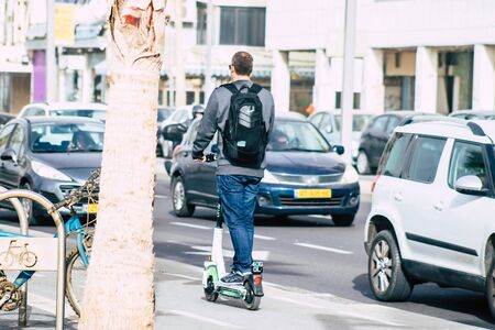 Tel Aviv Israel December 25, 2019 View of unidentified people rolling with a electric scooter in the streets of Tel Aviv in the afternoonの写真素材