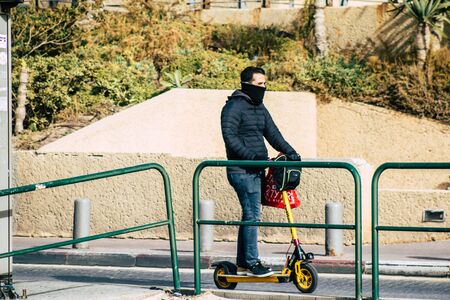 Tel Aviv Israel December 25, 2019 View of unidentified people rolling with a electric scooter in the streets of Tel Aviv in the afternoonの写真素材