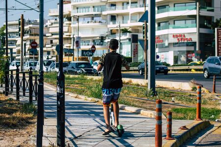 Athens Greece September 9, 2019 View of unknowns kids rolling with a electric scooter in the streets of Athens in the morningの写真素材