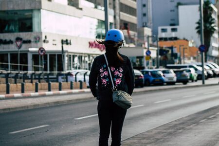 Tel Aviv Israel December 04, 2019 View of unknown Israeli people rolling with a electric scooter in the streets of Tel Aviv in the afternoonの写真素材