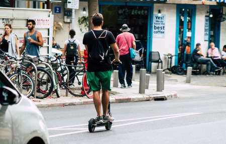 Tel Aviv Israel July 7, 2019 View of unknown Israeli people rolling with a electric scooter in the streets of Tel Aviv in the afternoonのeditorial素材