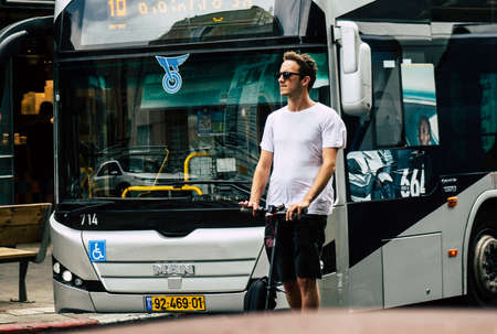 Tel Aviv Israel July 7, 2019 View of unknown Israeli people rolling with a electric scooter in the streets of Tel Aviv in the afternoonのeditorial素材