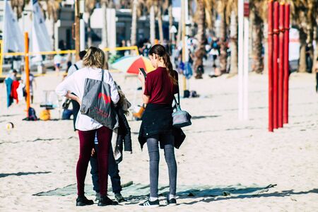 Tel Aviv Israel February 15, 2020 View of unidentified Israeli people having fun on the beach of Tel Aviv during a sunny day in winterの写真素材