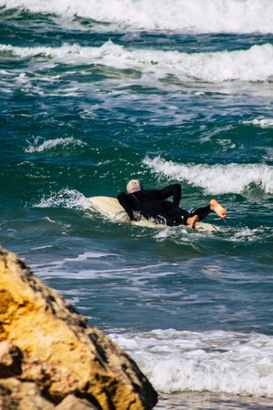 Tel Aviv Israel February 13, 2020 View of unidentified Israeli people having fun on the beach of Tel Aviv during a sunny day in winterの写真素材