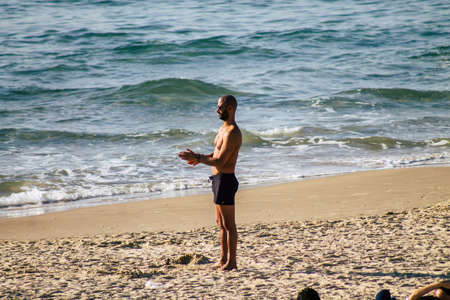 Tel Aviv Israel February 15, 2020 View of unidentified Israeli people having fun on the beach of Tel Aviv during a sunny day in winterのeditorial素材