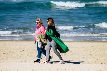 Tel Aviv Israel February 13, 2020 View of unidentified Israeli people having fun on the beach of Tel Aviv during a sunny day in winterのeditorial素材