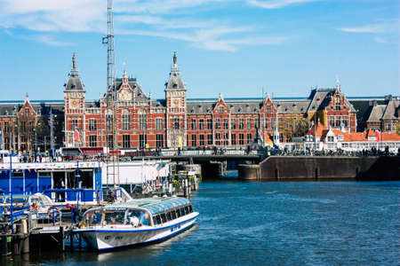 Amsterdam Netherlands April 22, 2019 View of the old Central train station located in Amsterdam during a sunny day in the eveningのeditorial素材