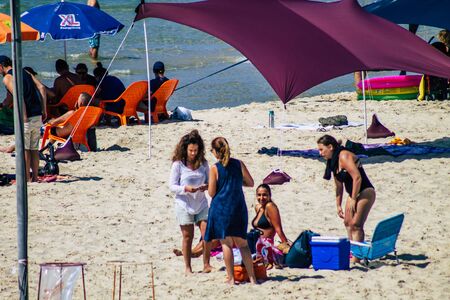 Tel Aviv Israel October 05, 2019 View of unknowns people having fun on the beach of Tel Aviv in the afternoonの写真素材