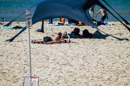 Tel Aviv Israel October 05, 2019 View of unknowns people having fun on the beach of Tel Aviv in the afternoonの写真素材