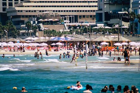 Tel Aviv Israel August 20, 2019 View of unknown Israeli people having fun on the beach of Tel Aviv during a sunny day in the afternoonの写真素材