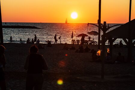 Tel Aviv Israel October 04, 2019 View of unknowns people having fun on the beach of Tel Aviv during the sunsetの写真素材