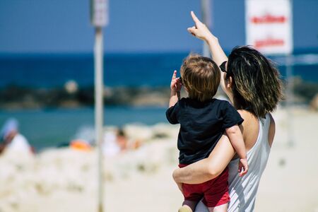 Tel Aviv Israel June 8, 2019 View of unknown Israeli children and parent having fun on the beach of Tel Aviv in the afternoonの写真素材