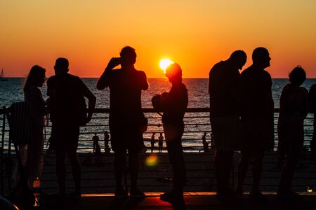 Tel Aviv Israel October 04, 2019 View of unknowns people having fun on the beach of Tel Aviv during the sunsetの写真素材
