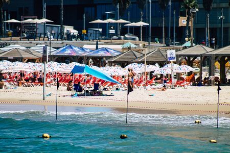 Tel Aviv Israel August 20, 2019 View of unknown Israeli people having fun on the beach of Tel Aviv during a sunny day in the afternoonの写真素材