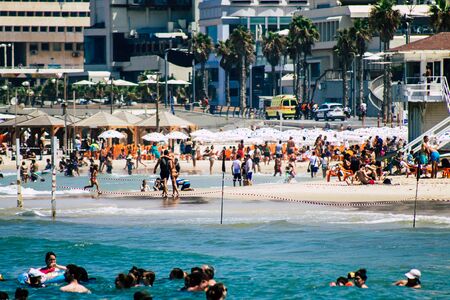 Tel Aviv Israel August 20, 2019 View of unknown Israeli people having fun on the beach of Tel Aviv during a sunny day in the afternoonの写真素材