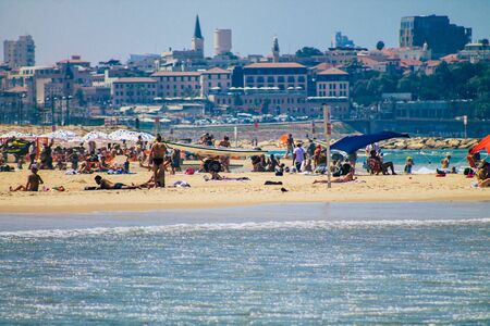 Tel Aviv Israel August 20, 2019 View of unknown Israeli people having fun on the beach of Tel Aviv during a sunny day in the afternoonの写真素材