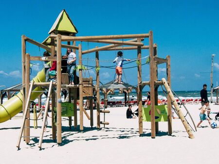 Tel Aviv Israel April 20, 2019 View of unknown Israeli kid having fun on the beach of Tel Aviv during a sunny day in the afternoonの写真素材