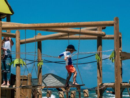 Tel Aviv Israel April 20, 2019 View of unknown Israeli kid having fun on the beach of Tel Aviv during a sunny day in the afternoonの写真素材