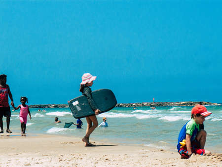 Tel Aviv Israel June 2, 2019 View of unknown Israeli children having fun on the beach of Tel Aviv in the afternoonのeditorial素材