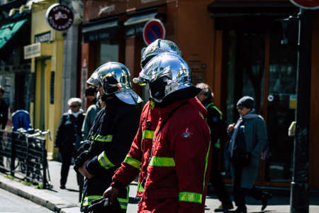 Paris France May 04, 2019 View of a French firefighters walking in the street during protests of the Yellow jackets against the policy of President Macron in Paris on saturday afternoonのeditorial素材