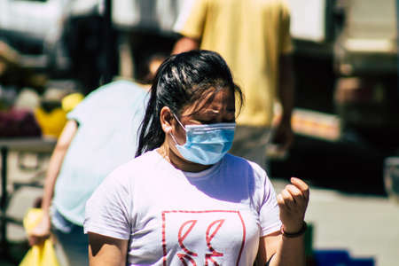 Limassol Cyprus June 13, 2020 Portrait of unidentified people with a face mask to protect themselves from the coronavirus shopping at the Limassol market in the morningのeditorial素材