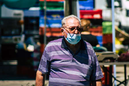 Limassol Cyprus June 13, 2020 Portrait of unidentified people with a face mask to protect themselves from the coronavirus shopping at the Limassol market in the morningのeditorial素材