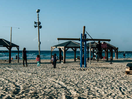 Tel Aviv Israel February 9, 2019 View of unknowns Israeli kids playing on the beach of Tel Aviv in the afternoonのeditorial素材