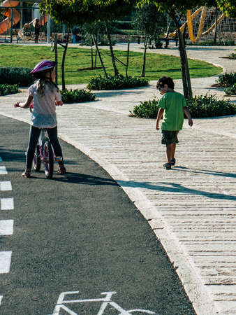 Jerusalem Israel September 11, 2018  View of Israeli kids playing with a bicycle in the street of Jerusalem in the afternoonのeditorial素材
