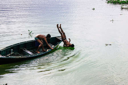 Pokhara Nepal September 29, 2018 View of unknowns Nepali kids playing in the Phewa lake in the afternoonのeditorial素材