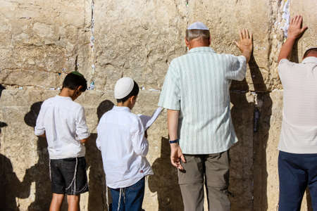 Jerusalem Israel May 14, 2018 Unknowns people and kids praying front the Western wall in the old city of Jerusalem in the eveningのeditorial素材