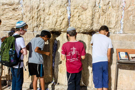 Jerusalem Israel May 14, 2018 Unknowns kids praying front the Western wall in the old city of Jerusalem in the eveningのeditorial素材