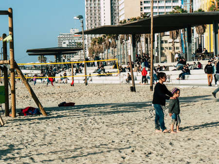 Tel Aviv Israel February 9, 2019 View of unknowns Israeli kids playing on the beach of Tel Aviv in the afternoonのeditorial素材