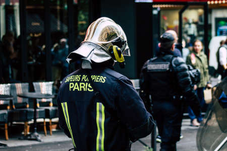Paris France May 04, 2019 View of a French firefighters walking in the street during protests of the Yellow jackets against the policy of President Macron in Paris on saturday afternoonのeditorial素材