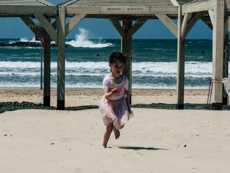 Tel Aviv Israel April 20, 2019 View of unknown Israeli kid having fun on the beach of Tel Aviv during a sunny day in the afternoonのeditorial素材