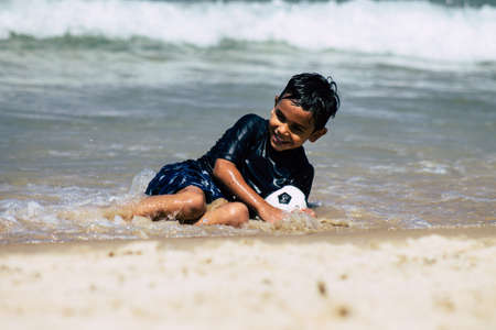 Tel Aviv Israel July 6, 2019 View of unknown Israeli child having fun on the beach of Tel Aviv during a sunny day in the afternoonのeditorial素材