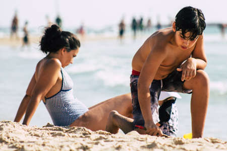 Tel Aviv Israel July 15, 2019 View of unknown child having fun on the beach of Tel Aviv during a sunny day in the afternoonのeditorial素材