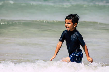Tel Aviv Israel July 6, 2019 View of unknown Israeli child having fun on the beach of Tel Aviv during a sunny day in the afternoonのeditorial素材