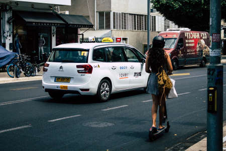 Tel Aviv Israel July 15, 2019 View of unknown Israeli people rolling with a electric scooter in the streets of Tel Aviv in the afternoonのeditorial素材