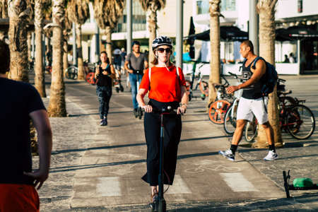 Tel Aviv Israel October 03, 2019 View of unknown Israeli people rolling with a electric scooter in the streets of Tel Aviv in the afternoonのeditorial素材