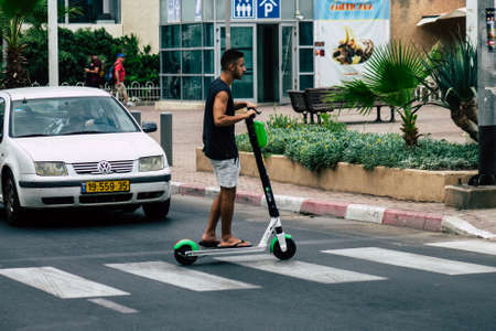 Tel Aviv Israel July 15, 2019 View of unknown Israeli people rolling with a electric scooter in the streets of Tel Aviv in the afternoonのeditorial素材