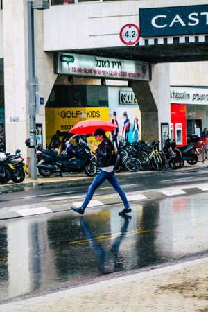 Tel Aviv Israel February 19, 2020 View of unidentified people walking in the streets of Tel Aviv during a raining day in winterのeditorial素材