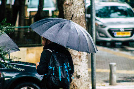 Tel Aviv Israel February 19, 2020 View of unidentified people walking in the streets of Tel Aviv during a raining day in winterのeditorial素材