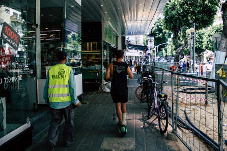 Tel Aviv Israel July 15, 2019 View of unknown Israeli people rolling with a electric scooter in the streets of Tel Aviv in the afternoonのeditorial素材
