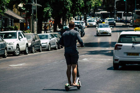 Tel Aviv Israel July 17, 2019 View of unknown Israeli people rolling with a electric scooters in the streets of Tel Aviv in the afternoonのeditorial素材