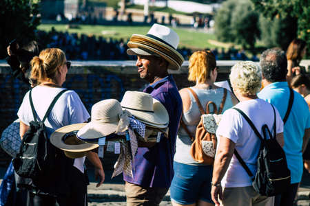 Rome Italy September 29, 2019 View of unknowns street vendor working front the Coliseum also known as the Flavian Amphitheatre in the center of the city of Romeのeditorial素材