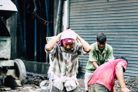Kathmandu Nepal August 24, 2018 View of unknowns Nepali worker building a new house in Durbar street in Kathmandu in the morningの写真素材