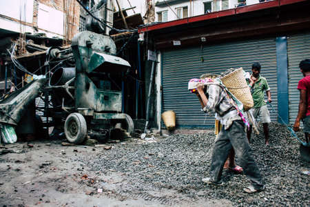 Kathmandu Nepal August 24, 2018 View of unknowns Nepali worker building a new house in Durbar street in Kathmandu in the morningのeditorial素材